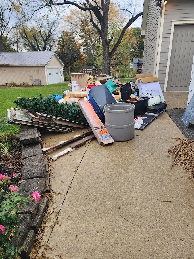 Dumpster being loaded with debris for Roofing Dumpster Rental in Clifton Park